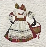 Antigua and Barbuda National Dress in vibrant madras fabric, featuring lace trim, a structured headpiece, and a patterned apron tied at the waist