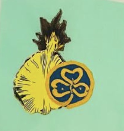 Quilted panel on a pale green background featuring a yellow pineapple beside a blue and gold Girl Guide trefoil emblem, symbolizing the union of Antiguan heritage and the global Guiding movement.